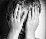 boy covering eyes