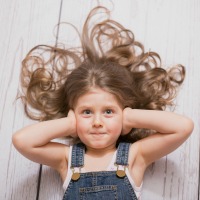 child covering ears