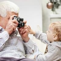 grandfather taking picture of grandson