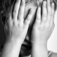 boy covering his eyes