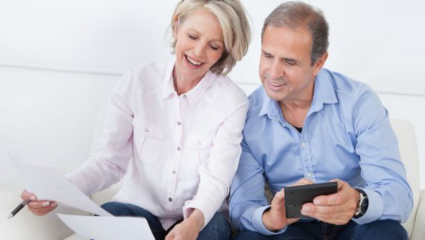 A husband and wife are planning with documents and a calculator