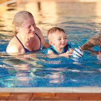 grandparents and grandchild swimming