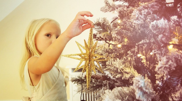 girl decorating christmas tree