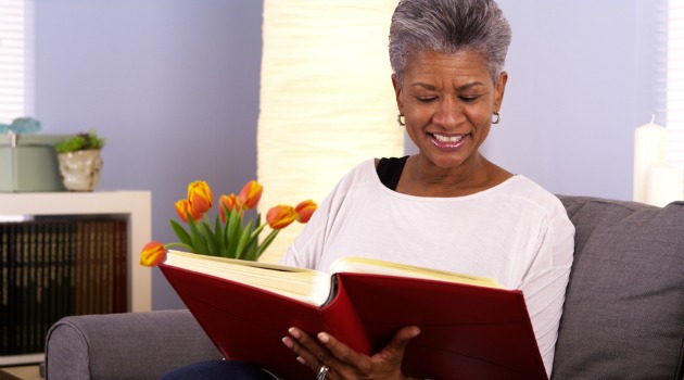 mature woman looking at photo album