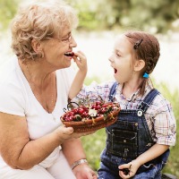 grandmother grandaughter garden eating cherries