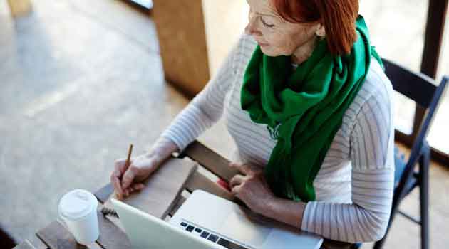 senior woman planning on pen paper