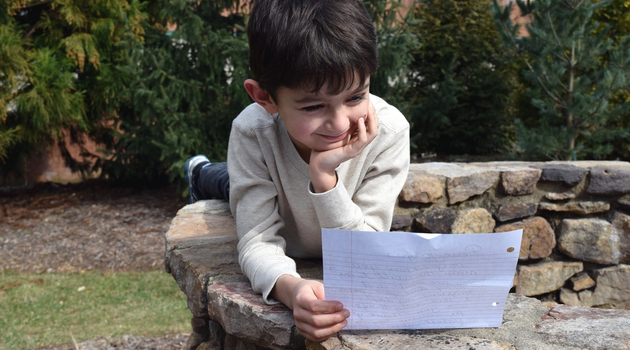 child reading letter