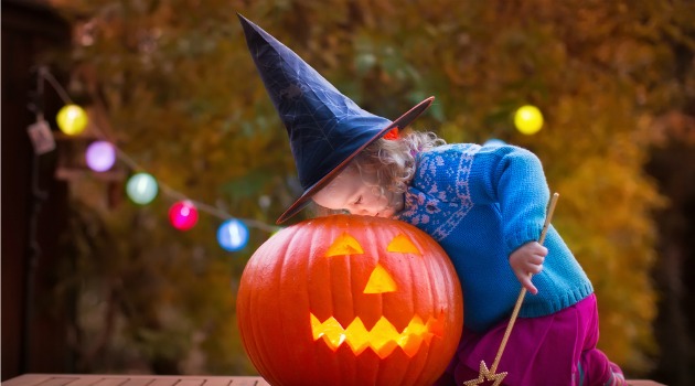 Toddler and pumpkin