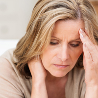 woman with hand to her forehead