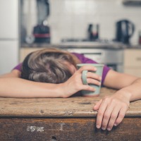 woman lying with head on a table