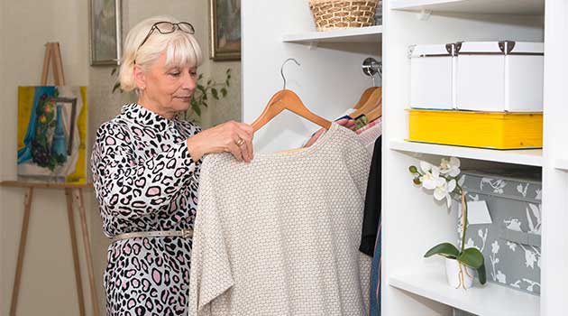 woman clearing out wardrobe