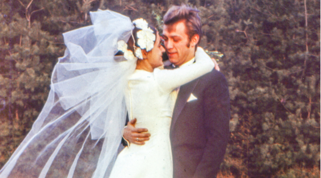 vintage newlyweds embracing in park