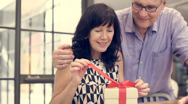mature couple opening gift