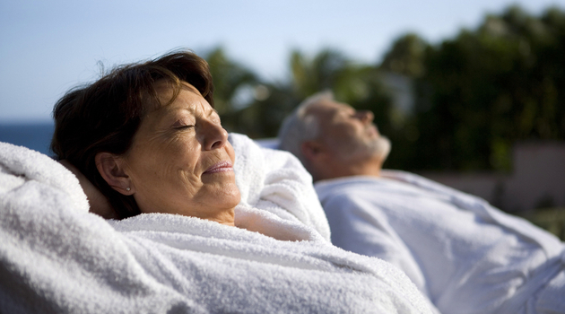 mature couple relaxing outdoors toweling robes