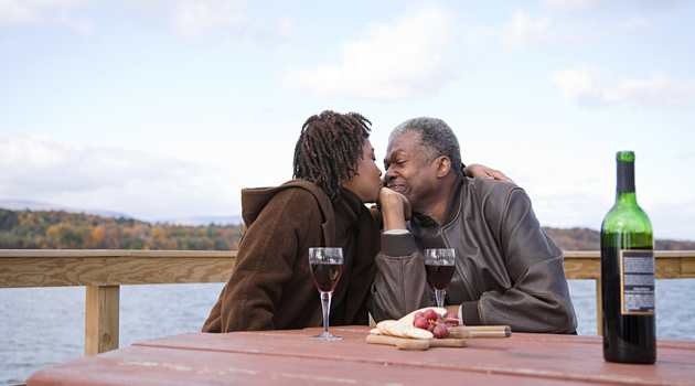 senior african american couple kissing by lake