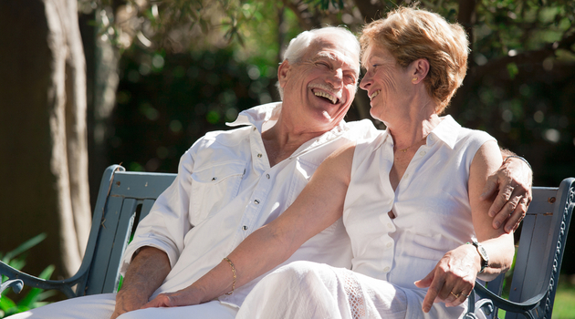 senior couple sitting bench