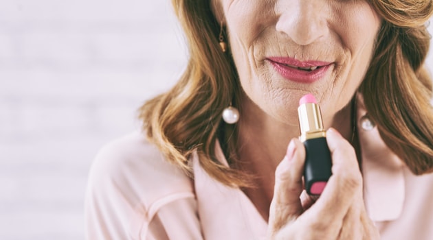 senior-woman-applying-lipstick