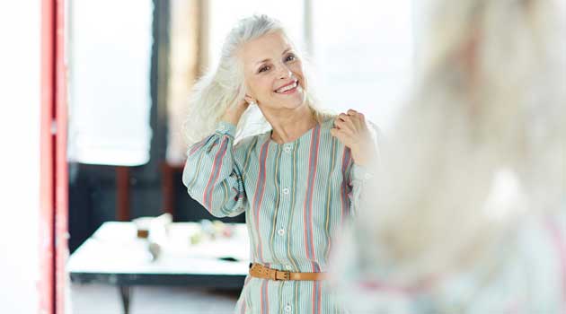 woman looking in mirror